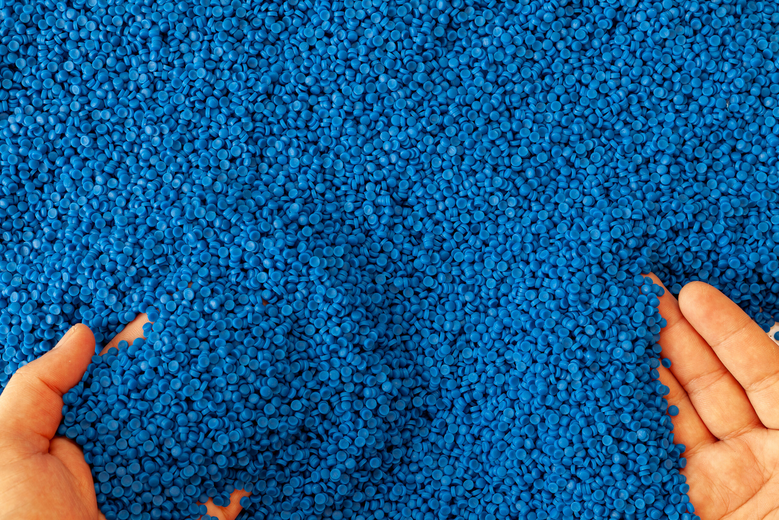 Close-up of plastic polymer granules. hand hold Polymer pellets. polymer plastic. compound polymer.